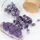 Glass and bamboo water bottle with amethyst crystals. Close up of crystals.